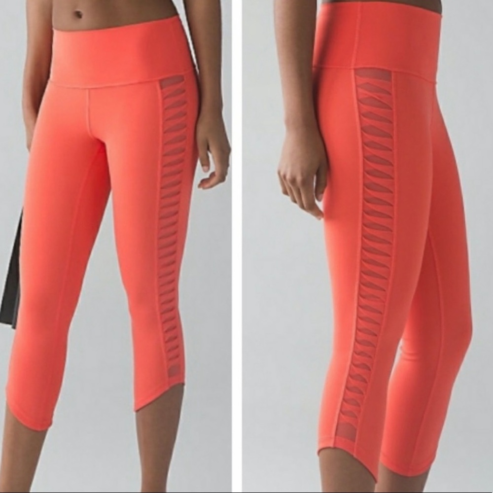 Lululemon cropped orange leggings with mesh detailing on sides